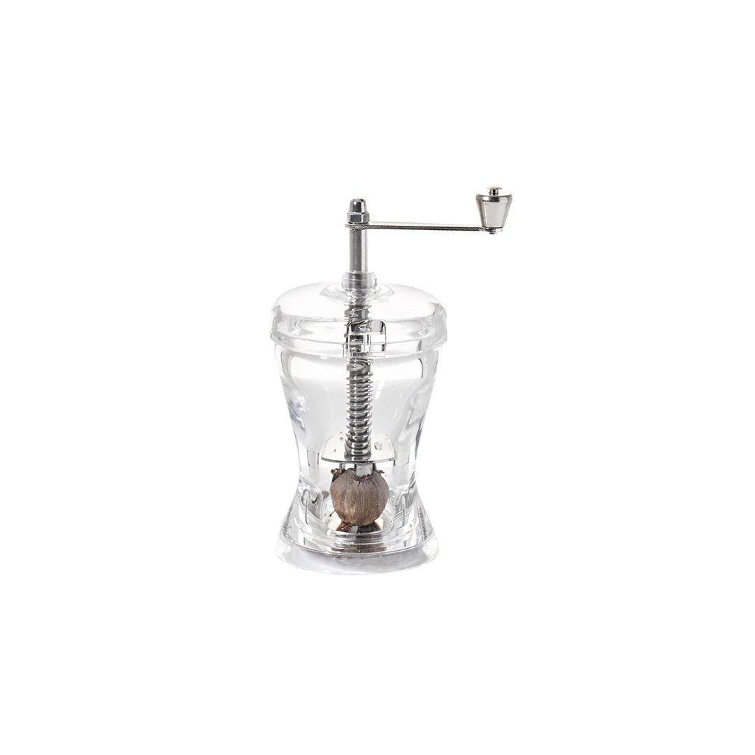Clear acrylic nutmeg grinder with stainless steel crank and internal grinding mechanism, designed for whole nutmeg use, available at Peppermill Imports.