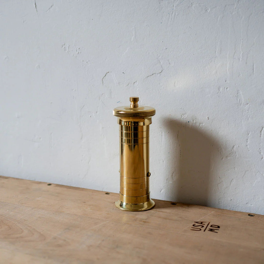 Brass Atlas Chef pepper mill with rotating top, used in Michelin-starred restaurants for precise grinding, available from Peppermill Imports.