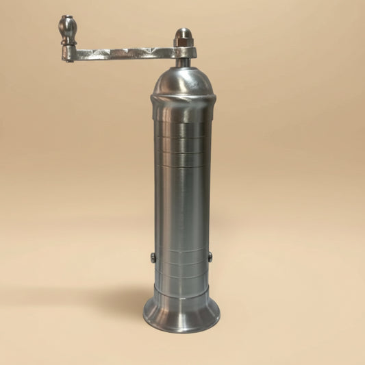 Metallic pepper grinder on a white background
