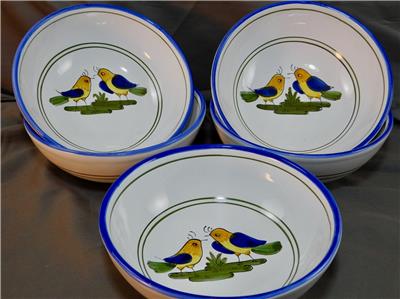 Set of ceramic bowls with bird design on a gray background