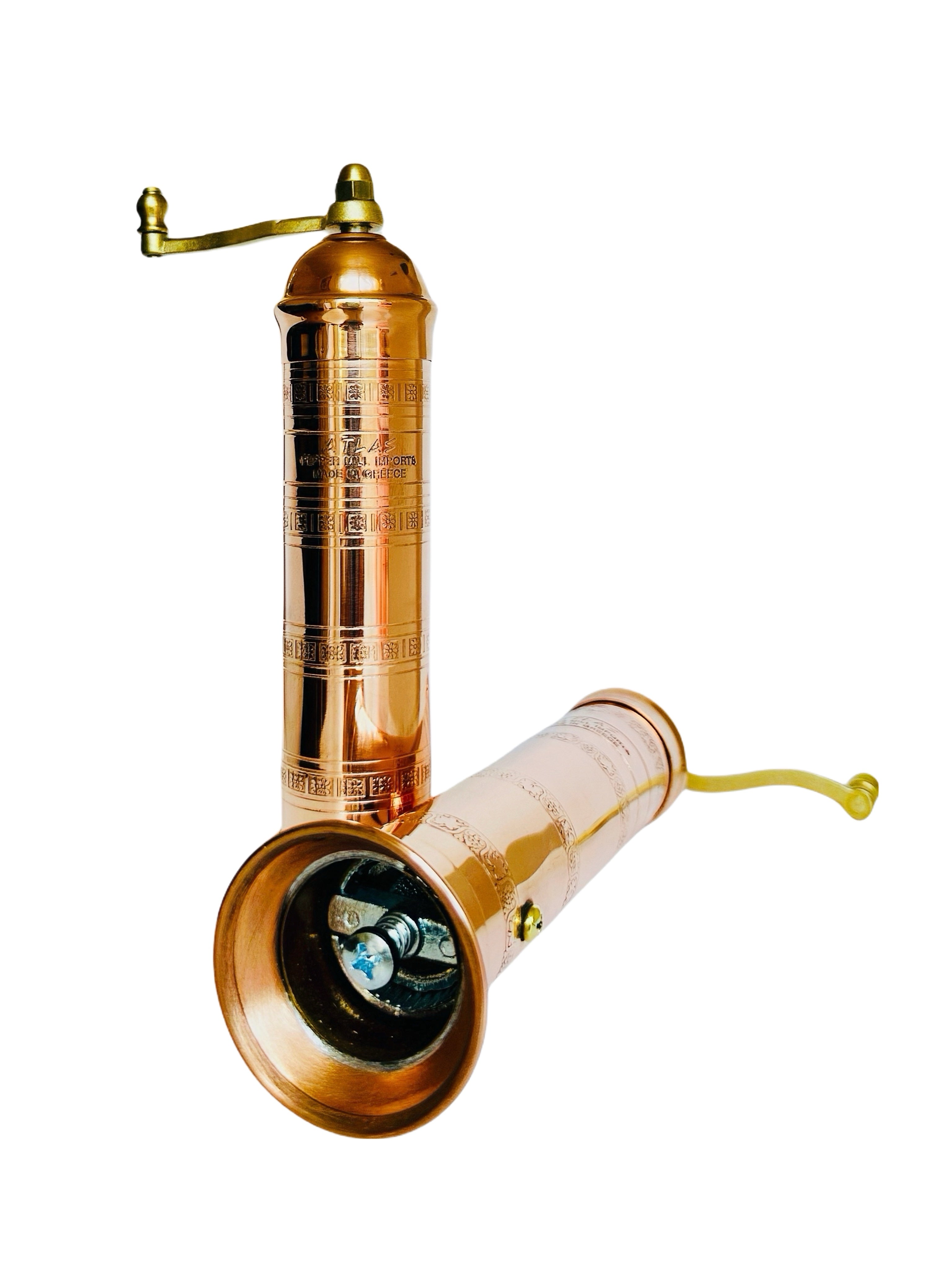 Copper pepper mill and salt mill salt on a white background